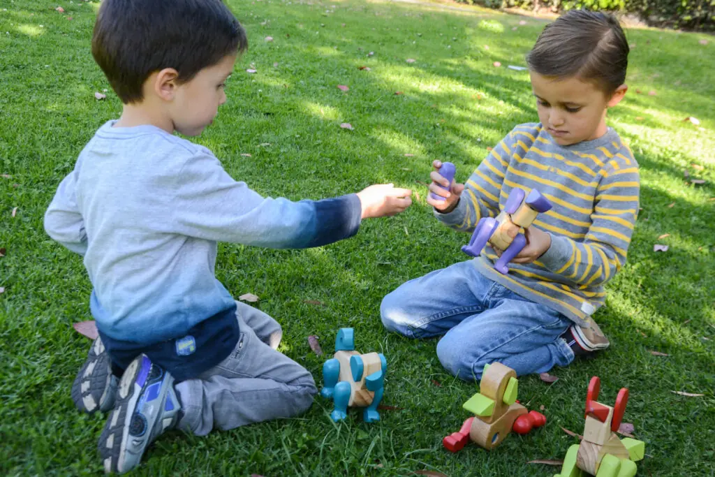 Little kids playing with Amalgama's Rune toys